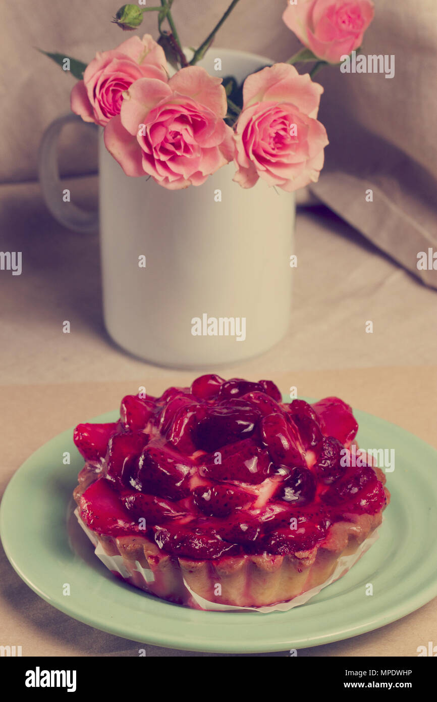 Strawberry tart and a bouquet of roses Stock Photo - Alamy