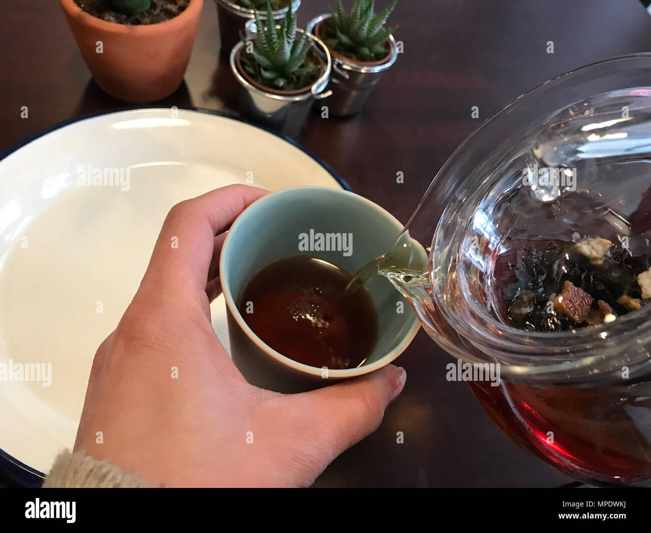 Glass Teapot Pouring Tea in Cup. Beverage Concept Stock Photo Alamy