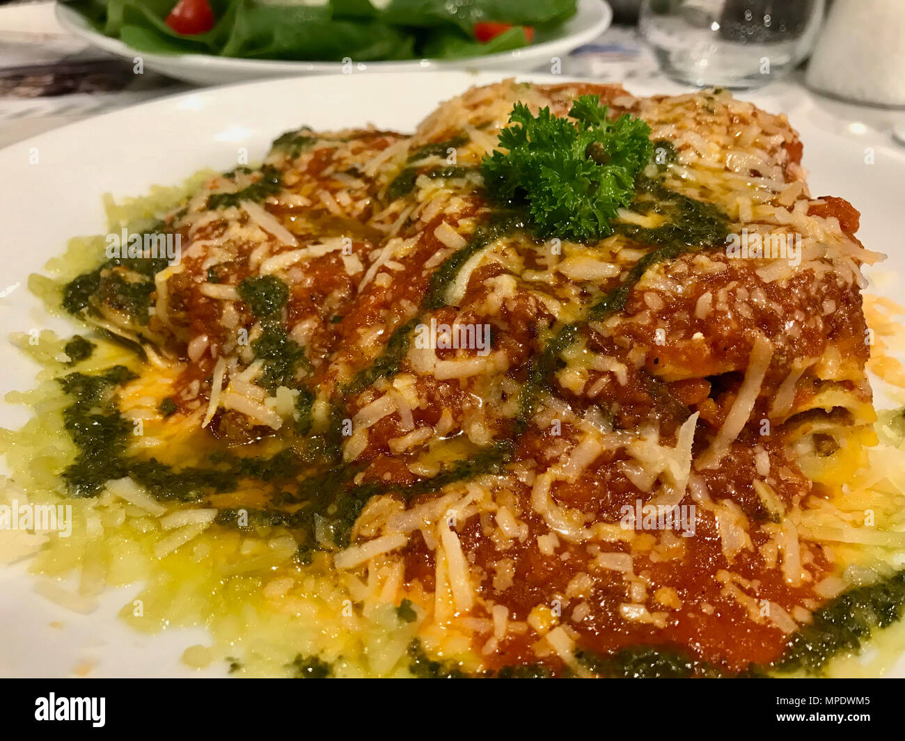 Traditional Minced Meat Lasagna with Bolognese and Pesto Sauce served