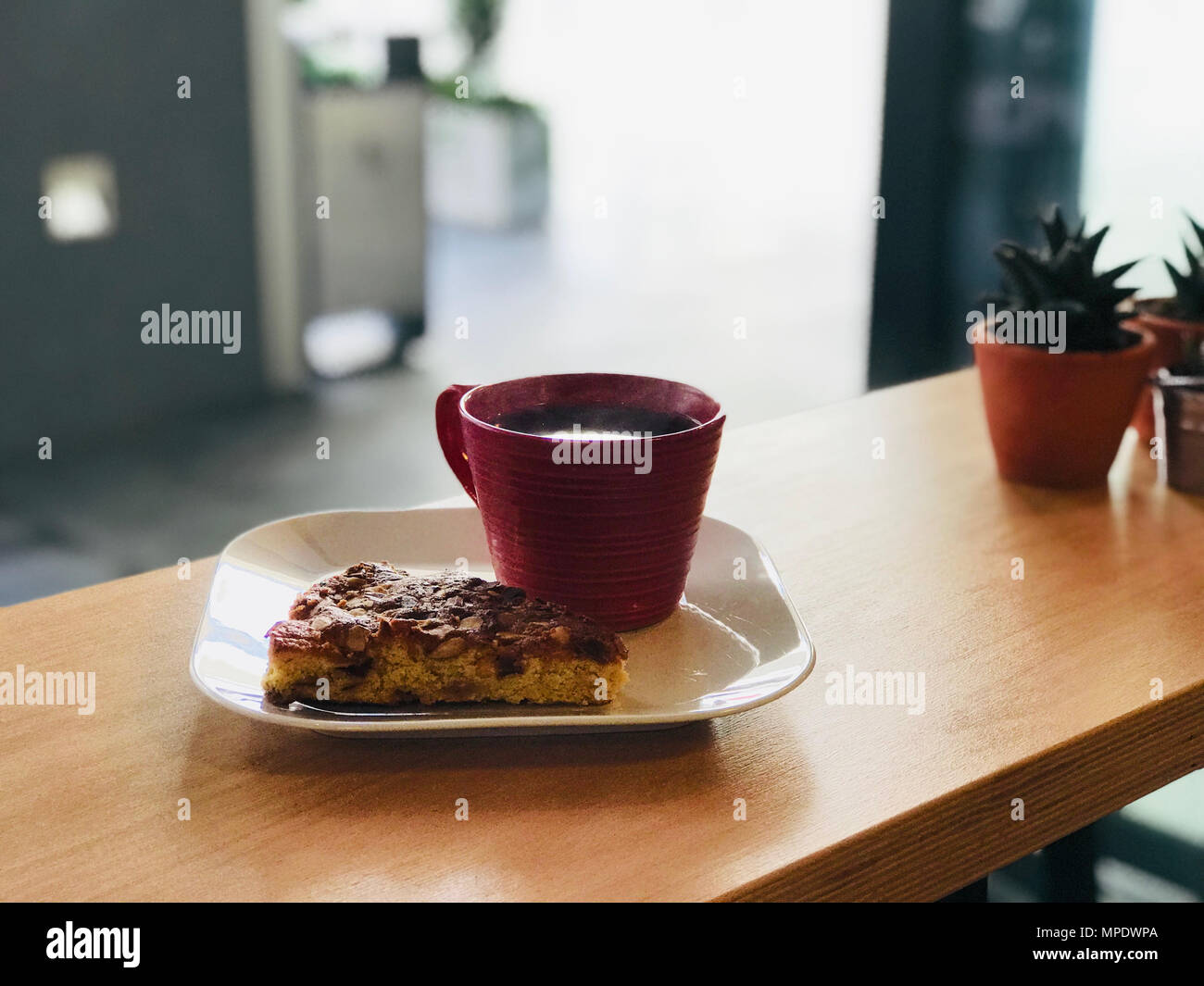 Crispy Cake Slice with Almond and Plums and Fresh Filter Coffee at Cafe