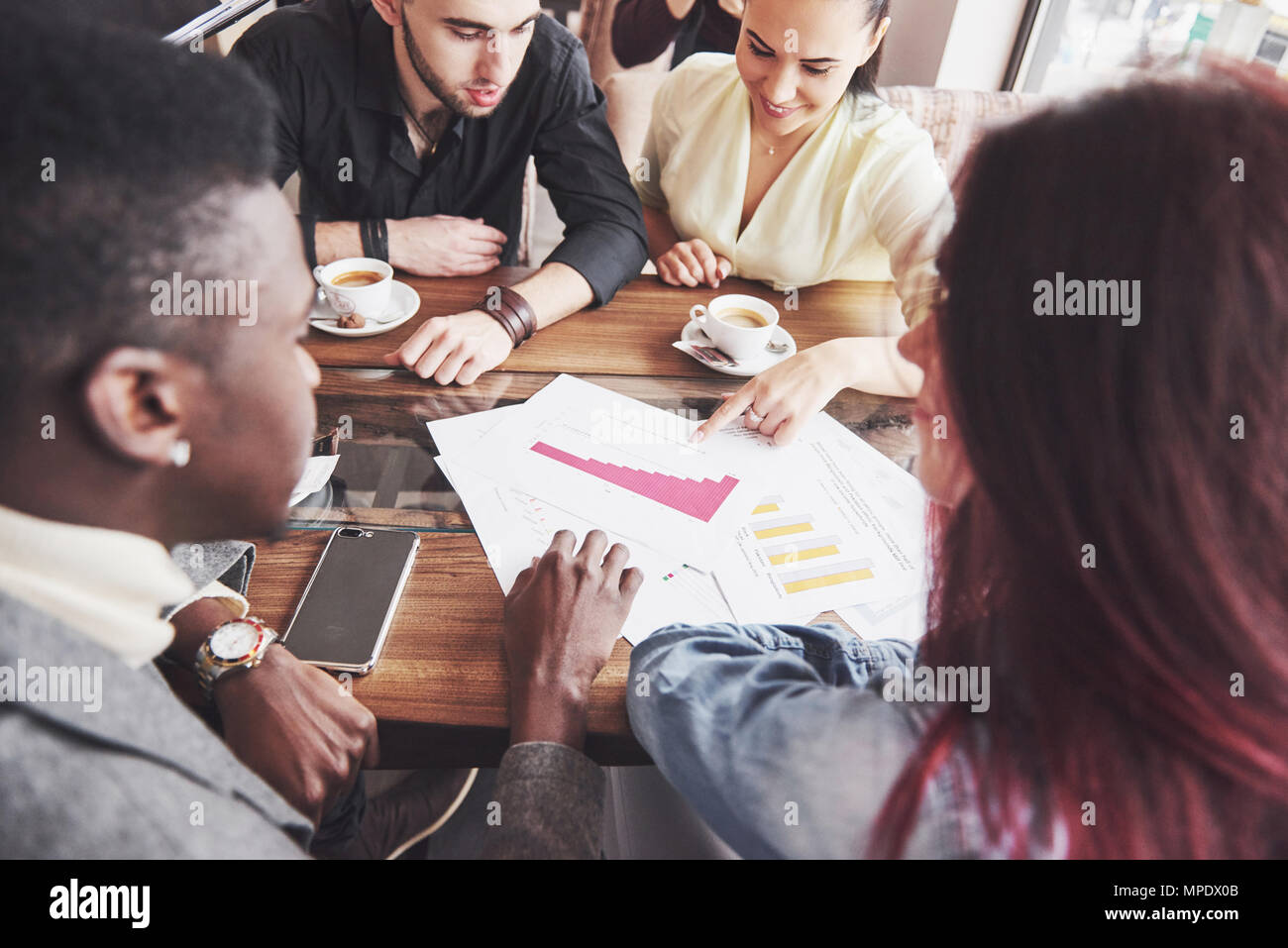 Startup Diversity Teamwork Brainstorming Meeting Concept. Business Team Coworkers Sharing World Economy Report Document Laptop.People Working Planning Start Up.Group Young Hipsters Discussing Cafe Stock Photo