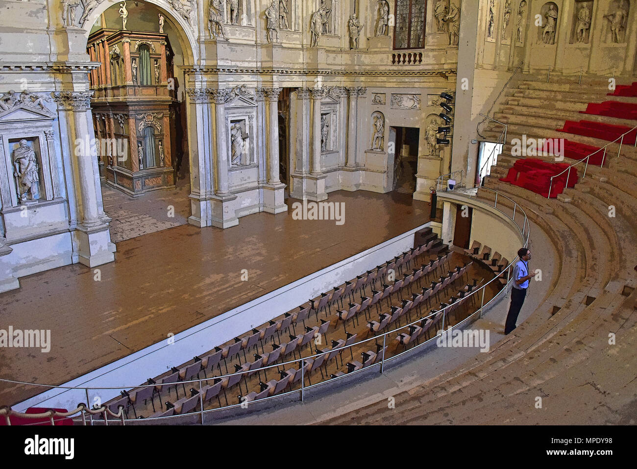 Teatro Olimpico (Renaissance theater), interior view, showing the semi-elliptical auditorium  and stage (with a tour guide) rendered in PS, by Palladi Stock Photo