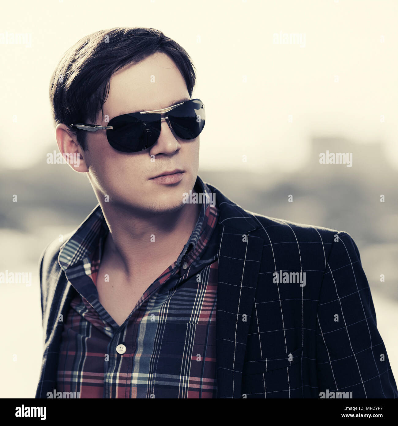 Young handsome fashion man in sunglasses outdoor Stock Photo
