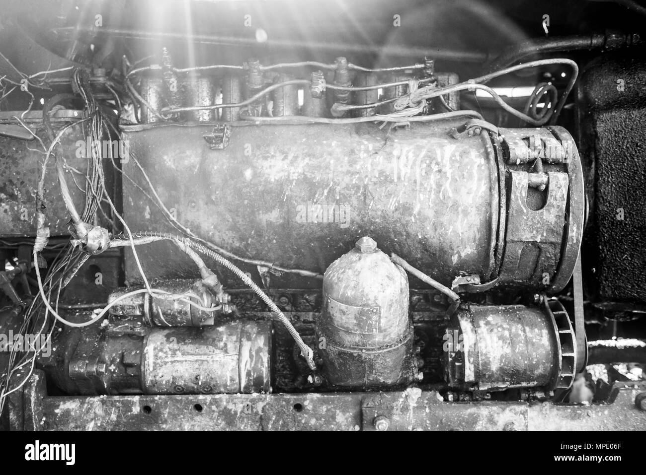 Sunlight Engine Engine of retro tractor, sunlight is scattered from above, monochrome ...