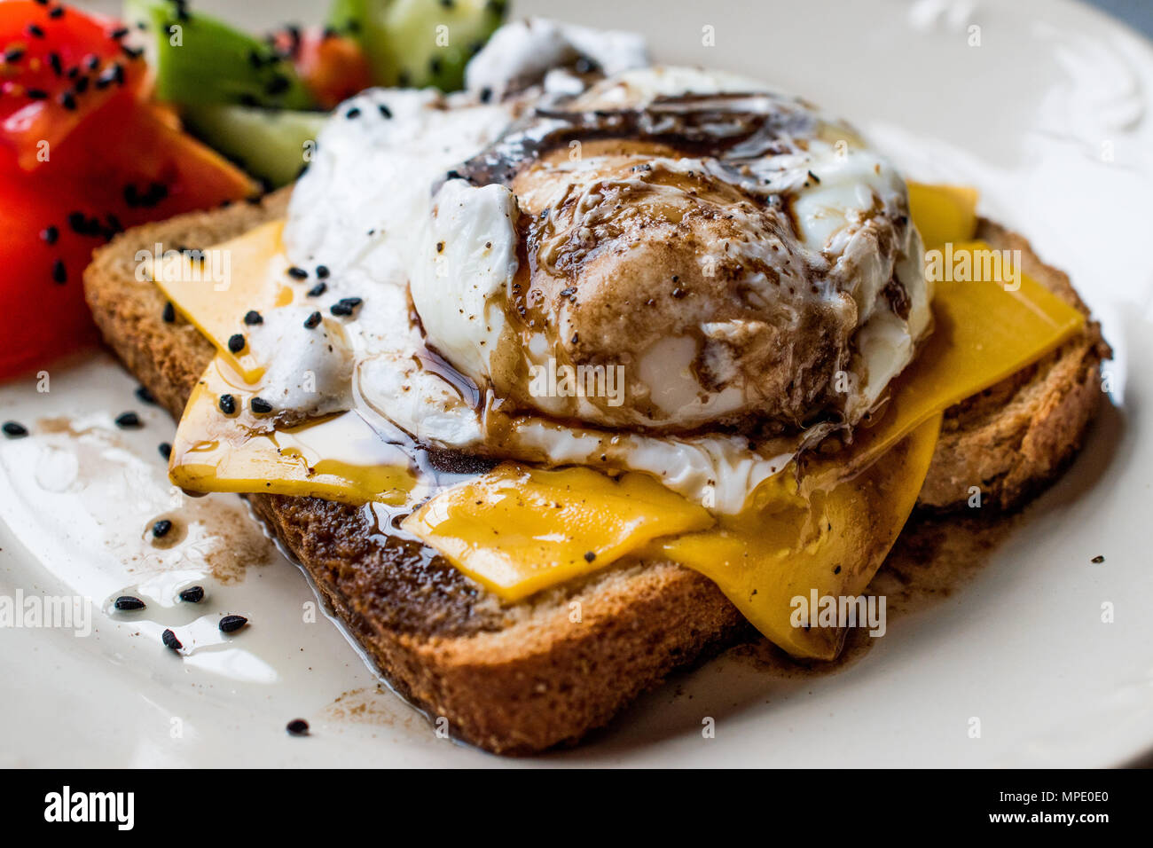 Poached Egg on Toast Bread with Cheddar Cheese, Balsamic Vinegar, Salad