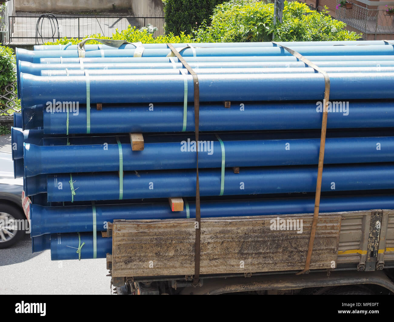 Transported large blue pipes being transported on a truck Stock Photo - Alamy