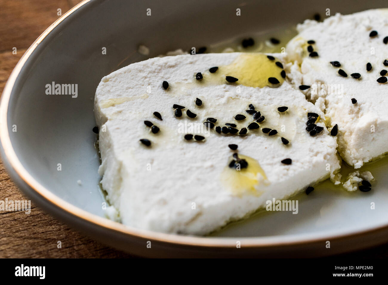 Cokelek or lor peyniri / Curd Cheese with olive oil and black cumin. Organic Food. Stock Photo