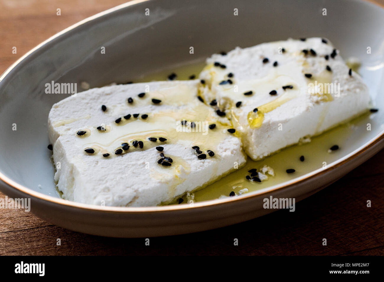 Cokelek or lor peyniri / Curd Cheese with olive oil and black cumin. Organic Food. Stock Photo