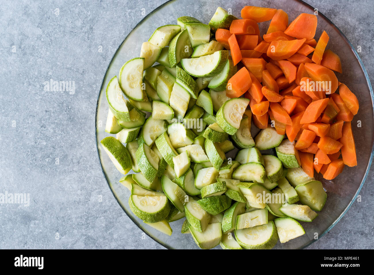 Chopped Zucchini and Carrot Slices in Glass Bowl. Organic Food Stock