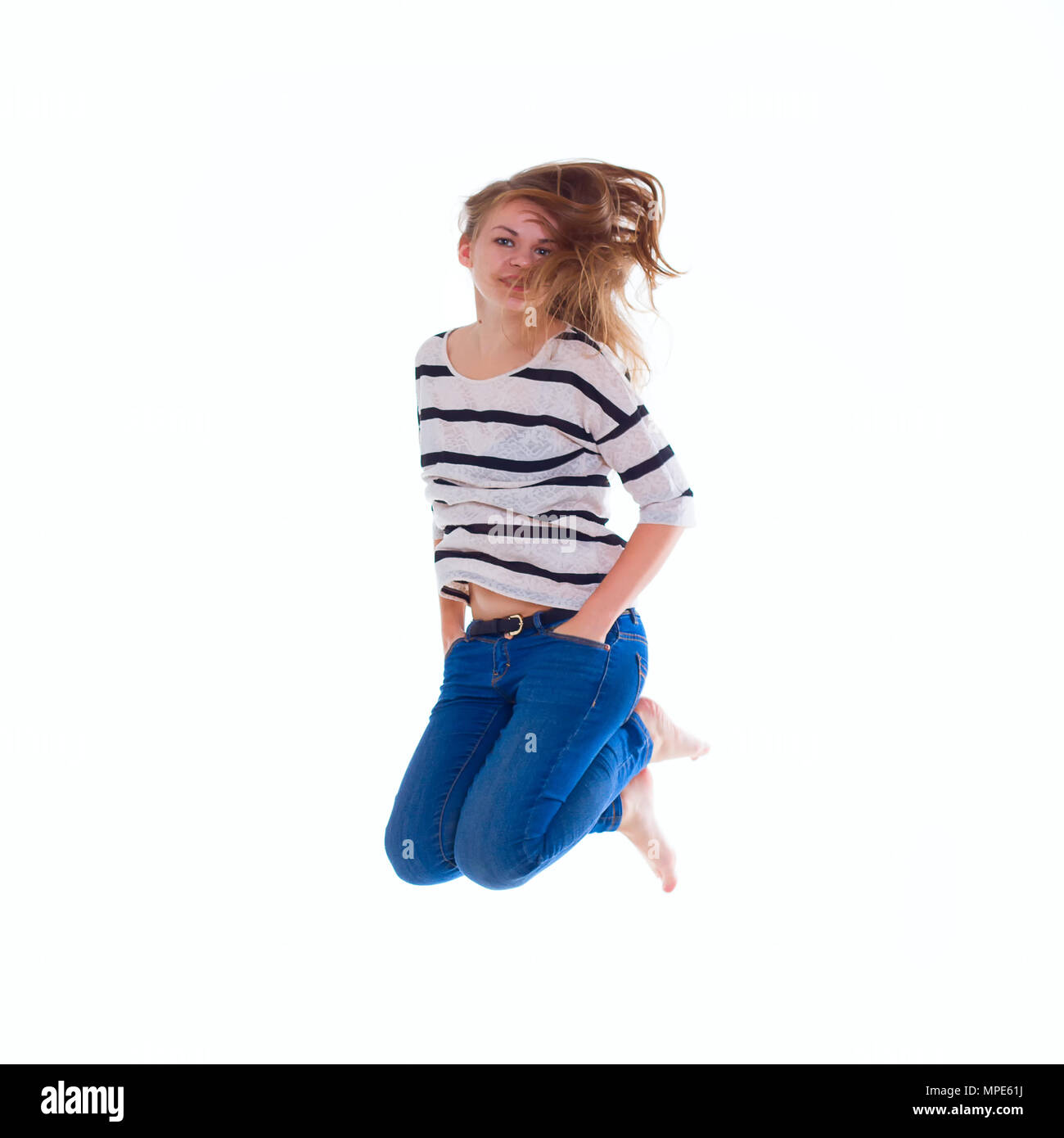 activity and happiness concept - smiling  girl in white blank t-shirt jumping Stock Photo