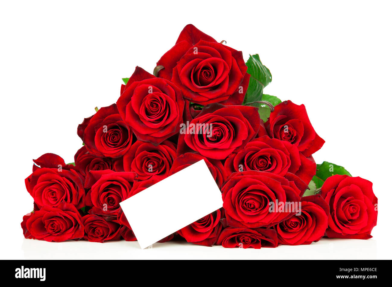 Bunch of red roses and a greeting card isolated on white background ...