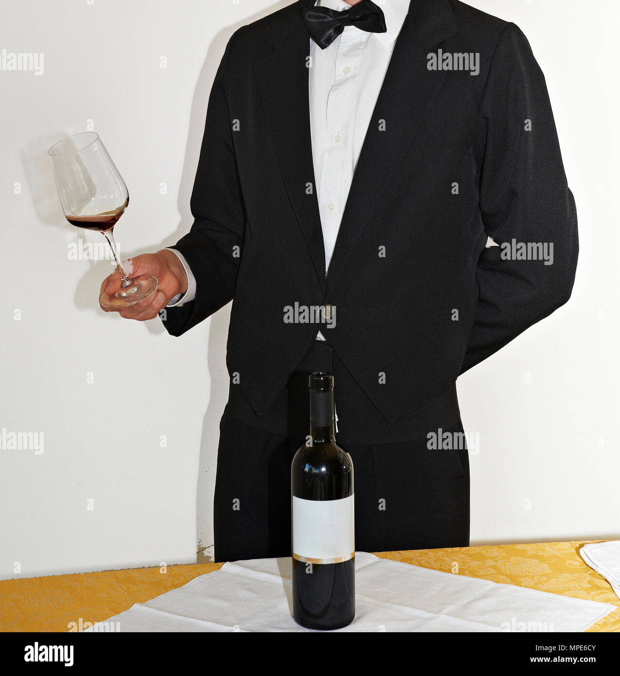 a sommelier pours the wime into a glass Stock Photo