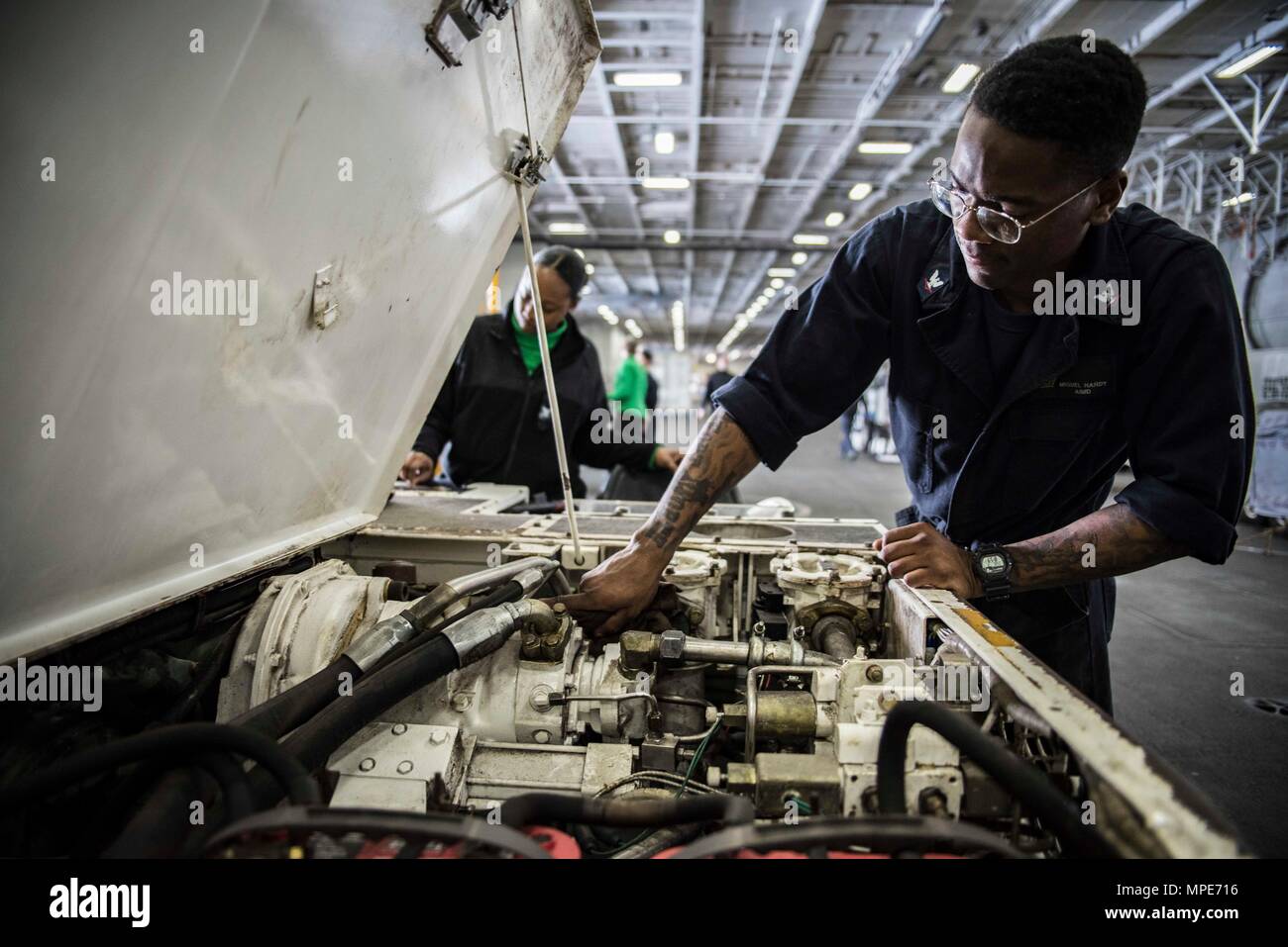 170207-N-IE397-013   ATLANTIC OCEAN (Feb 7, 2017) Aviation Support Equipment Technician 3rd Class Miguel Hardy, from Ft. Worth, Texas, conducts maintenance on a flight deck tractor in the hangar bay of the aircraft carrier USS Dwight D. Eisenhower (CVN 69) (Ike). Ike is currently conducting aircraft carrier qualifications during the sustainment phase of the Optimized Fleet Response Plan (OFRP). (U.S. Navy photo by Mass Communication Specialist 3rd Class Christopher A. Michaels) Stock Photo