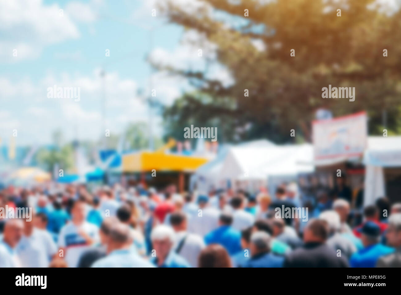 Crowd of people on open air festival, abstract blurred background as graphic design element Stock Photo