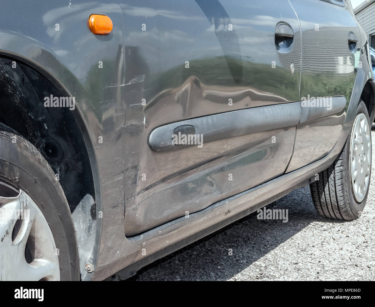 Close Up Detail Of A Dented Driver Door From A Car Crash Or