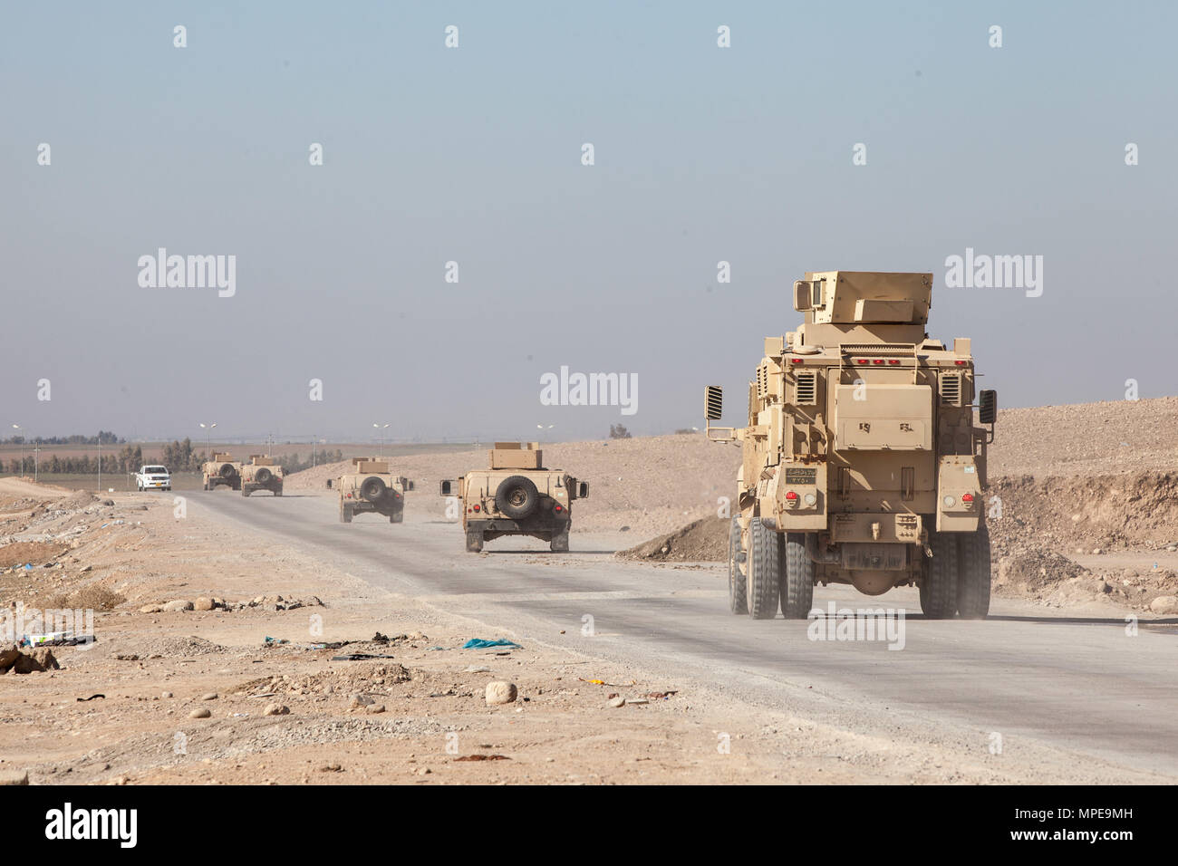 Peshmerga soldiers drive Humvees and a MaxxPro mine resistant, ambush-protected vehicle in a convoy as part of driver’s training provided by German soldiers near Erbil, Iraq, Feb. 8, 2017. More than 60 Coalition partners have committed themselves to the goal of eliminating the threat posed by ISIL in Iraq and Syria and have contributed in various capacities to the effort. Combined Joint Task Force – Inherent Resolve is the global Coalition to defeat ISIL in Iraq and Syria. (U.S. Army photo by Sgt. Josephine Carlson) Stock Photo