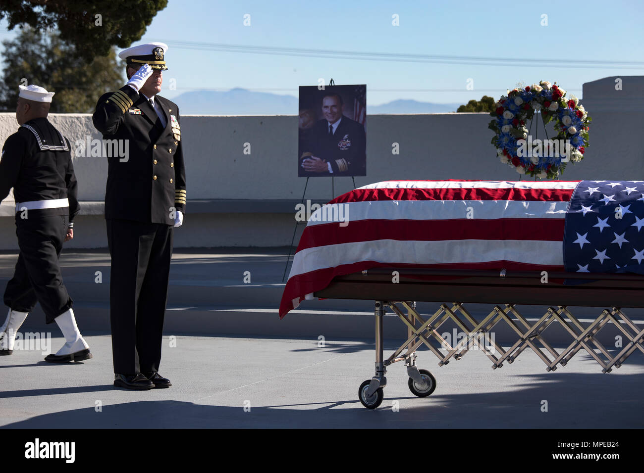 170213-N-PJ969-0093 SAN DIEGO (Feb. 13, 2017) Capt. Cory Cathcart, force chaplain, Naval Special Warfare Command, salutes the casket of retired Rear Adm. (SEAL) Richard Lyon during a memorial service held at Fort Rosecrans National Cemetery. Adm. Lyon passed away Feb. 3, 2017 at the age of 93. He served more that 40 years in the Navy, including tours in WWII and the Korean War and was the first SEAL admiral. (U.S. Navy photo by Petty Officer 2nd Class Abe McNatt) Stock Photo