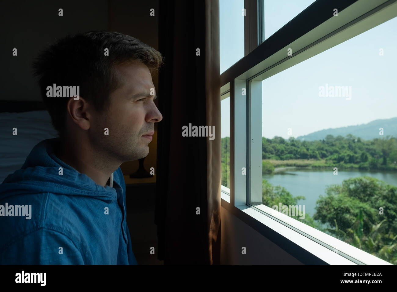 Young Man by the Window Looking Outside Stock Photo - Image of  disappointment, grief: 85427746