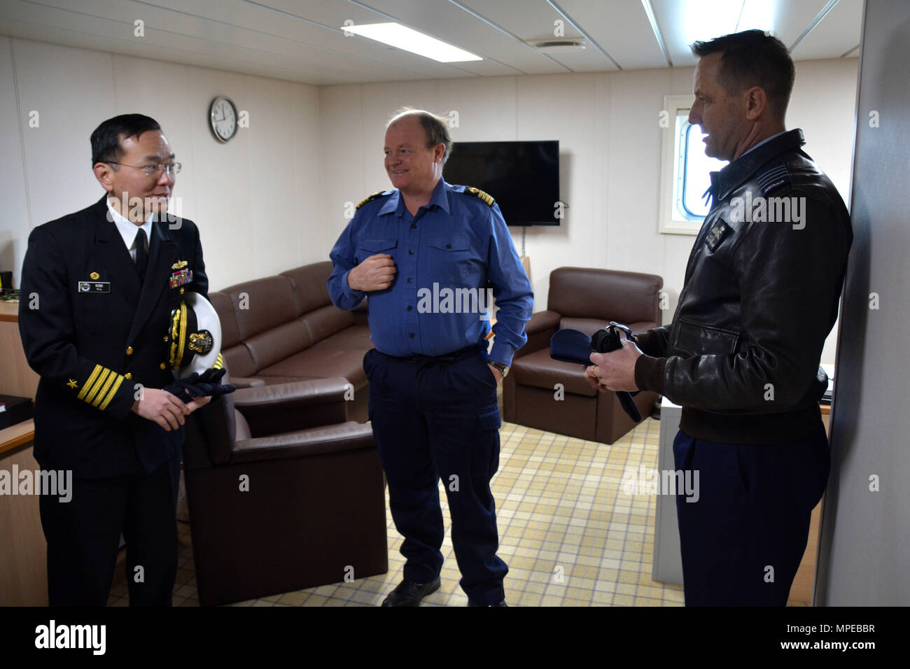 YOKOSUKA, Japan (Feb. 11, 2017) – Capt. Jeffrey Kim (left), Commander, Fleet Activities Yokosuka (CFAY) and Capt. Michael Jansen (right), Commander United Nations Command (Rear) welcome Capt. Shaun Jones (middle) from Royal Fleet Auxiliary (RFA) Tidespring (A136) to Fleet Activities (FLEACT) Yokosuka. RFA Tidespring is the first Tide-class tanker the Royal Navy has taken delivery of from South Korean shipbuilding company Daewoo Shipbuilding & Marine Engineering (DSME). Tidespring’s port call to FLEACT Yokosuka was a scheduled visit sponsored by the United Nations Command (Rear). FLEACT provide Stock Photo