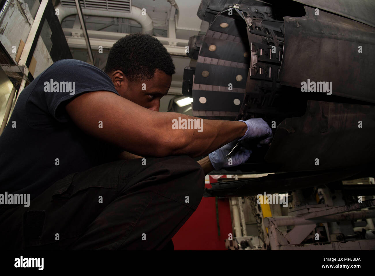 170211-N-KJ380-078  ATLANTIC OCEAN (Feb. 11, 2017) Aviation Machinist's Mate Airman Trevaughn Whiteman, from Windsor, Conn., conducts maintenance on an afterburner of an F/A-18 Super Hornet engine in the jet shop of the aircraft carrier USS Dwight D. Eisenhower (CVN 69) (Ike). Ike is currently conducting aircraft carrier qualifications during the sustainment phase of the Optimized Fleet Response Plan (OFRP). (U.S. Navy photo by Mass Communication Specialist Seaman Neo Greene III) Stock Photo