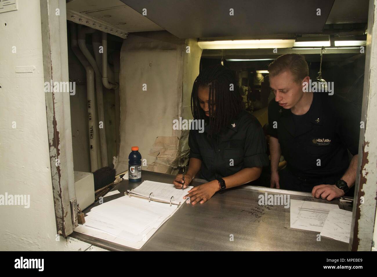 170211-N-KJ380-046  ATLANTIC OCEAN (Feb. 11, 2017) Electrician's Mate 3rd Class Precious Aducei, from Orange, N.J., and Machinist's Mate 3rd Class Damion Switzer, from San Diego, check in laundry bags in the bulk laundry room of the aircraft carrier USS Dwight D. Eisenhower (CVN 69) (Ike). Ike is currently conducting aircraft carrier qualifications during the sustainment phase of the Optimized Fleet Response Plan (OFRP). (U.S. Navy photo by Mass Communication Specialist Seaman Neo Greene III) Stock Photo