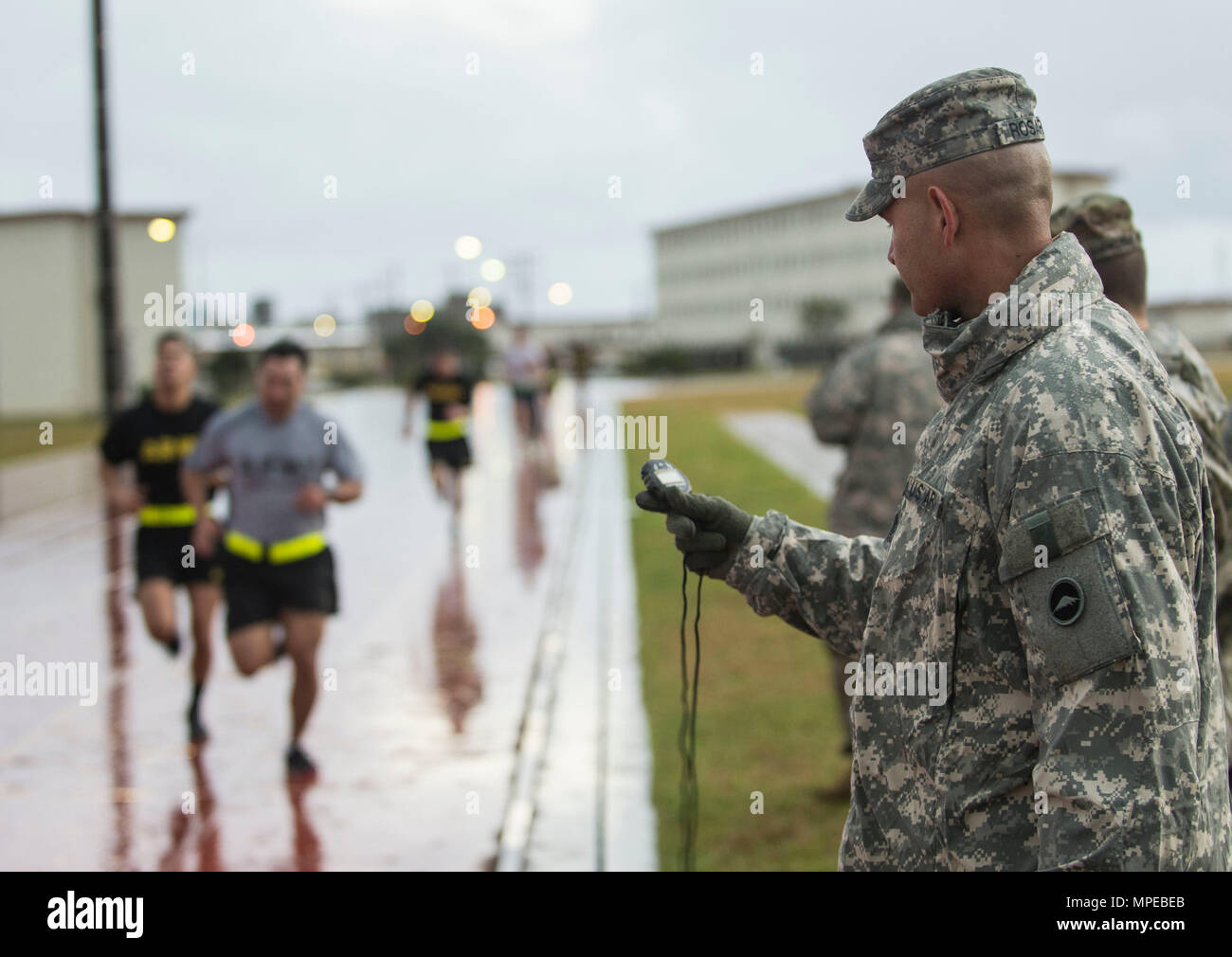Camp Hansen, Okinawa (Feb 08, 2017) – Sgt. Maj. Juan Rosario-Montalvo monitors Soldiers and Airmens times as part of a graded fitness test during the US Army Japans best warrior competition. The top competitors of this competition will continue on to compete in a pacific-wide competition in Hawaii. (U.S. Navy photo by Mass Communication Specialist Taylor Mohr) Stock Photo