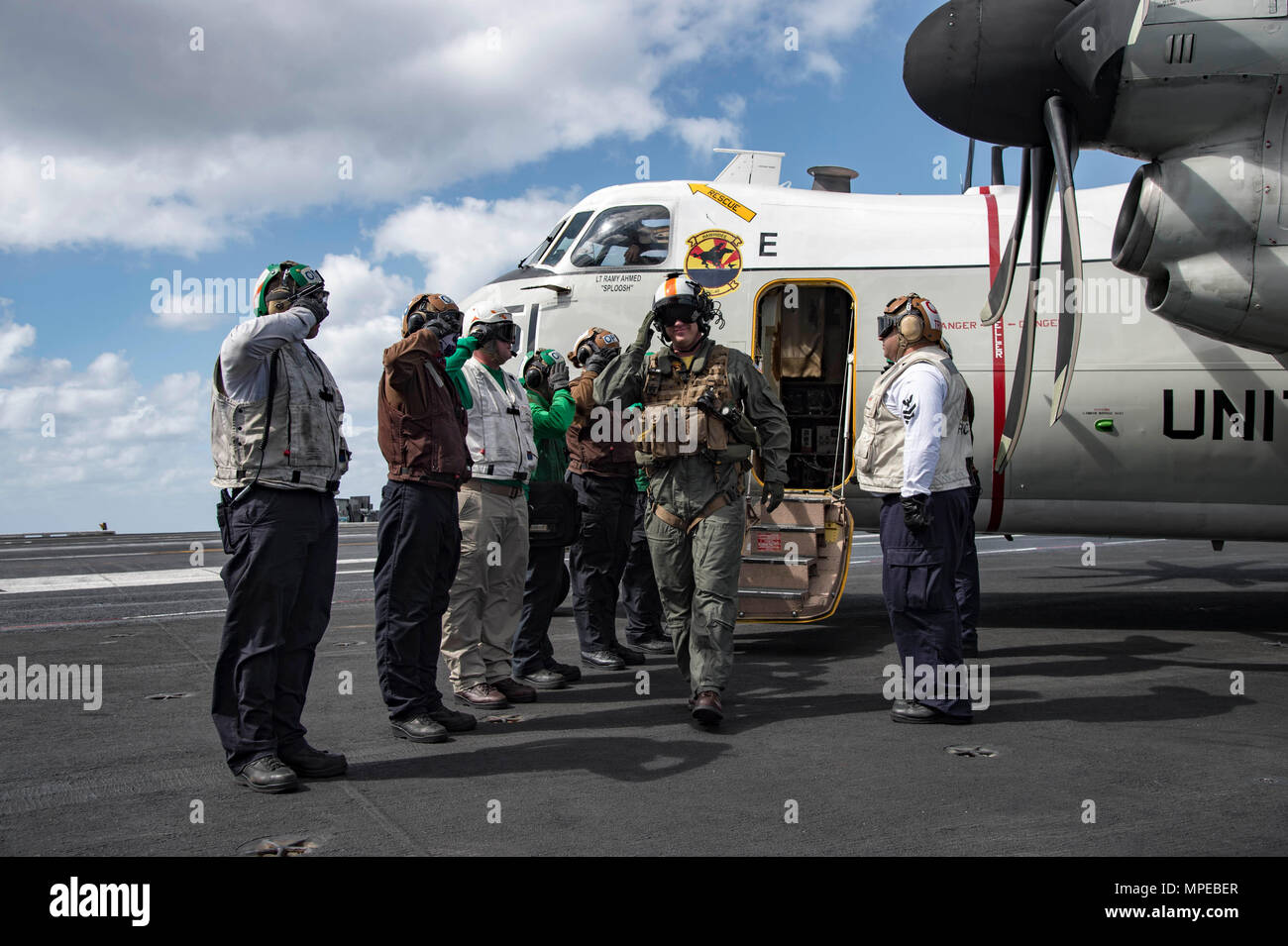 170211-N-OS569-435  ATLANTIC OCEAN (Feb. 11, 2017) Cmdr. Mark Litowski, commanding officer of the Rawhides of Fleet Logistics Support Squadron (VRC) 40, salutes the sideboys as he exits the cockpit of a C-2A Greyhound after makiing the last arrested landing of his career on the flight deck of the aircraft carrier USS Dwight D. Eisenhower (CVN 69) (Ike). Ike is currently conducting aircraft carrier qualifications during the sustainment phase of the Optimized Fleet Response Plan (OFRP). (U.S. Navy photo by Mass Communication Specialist Seaman Zach Sleeper) Stock Photo