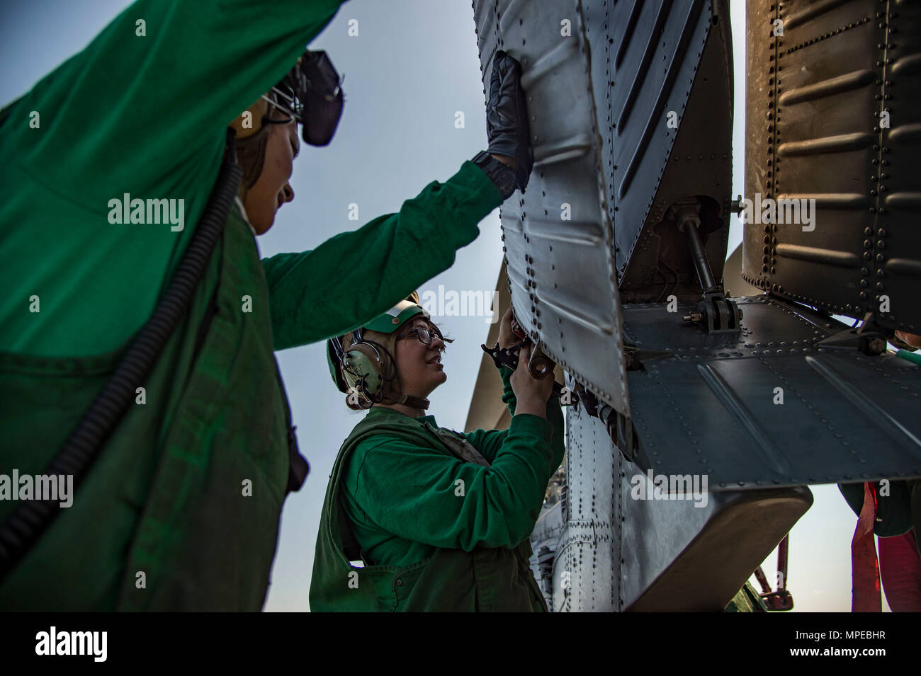 170209-N-OS569-061  ATLANTIC OCEAN (Feb. 9, 2017) Aviation Electrician’s Mate 3rd Class Dealba Manzanite, right, and Aviation Structural Mechanic Airman Mileika Miki, conduct maintenance on an MH-60S Sea Hawk helicopter assigned to the Dragon Whales of Helicopter Sea Combat Squadron (HSC) 28 on the flight deck of the aircraft carrier USS Dwight D. Eisenhower (CVN 69) (Ike). Ike is currently conducting aircraft carrier qualifications during the sustainment phase of the Optimized Fleet Response Plan (OFRP). (U.S. Navy photo by Mass Communication Specialist Seaman Zach Sleeper) Stock Photo