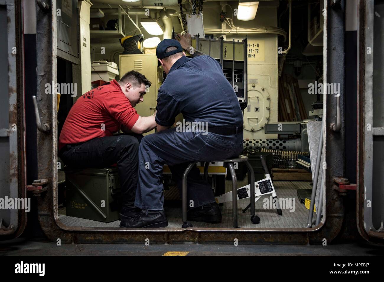 170212-N-IE397-011  ATLANTIC OCEAN (Feb 12, 2017) Aviation Ordnanceman Airman Aaron Dates, from Atlanta, left, and Aviation Ordnanceman 2nd Class Samuel Canning, from St. John's, Newfoundland, Canada, conduct maintenance on a link-less ammunition loading system in the ordnance shop of the aircraft carrier USS Dwight D. Eisenhower (CVN 69) (Ike). Ike is currently conducting aircraft carrier qualifications during the Sustainment Phase of the Optimized Fleet Response Plan (OFRP). (U.S. Navy photo by Mass Communication Specialist 3rd Class Christopher A. Michaels) Stock Photo