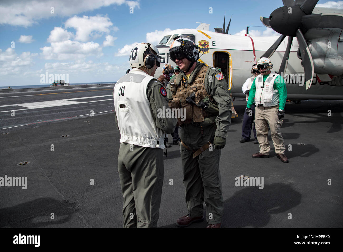 170211-N-OS569-445  ATLANTIC OCEAN (Feb. 11, 2017) Capt. Paul C. Spedero Jr., left, commanding officer of the aircraft carrier USS Dwight D. Eisenhower (CVN 69) (Ike) greets Cmdr. Mark Litowski, commanding officer of the Rawhides of Fleet Logistics Support Squadron (VRC) 40, on the flight deck. Ike is currently conducting aircraft carrier qualifications during the sustainment phase of the Optimized Fleet Response Plan (OFRP). (U.S. Navy photo by Mass Communication Specialist Seaman Zach Sleeper) Stock Photo