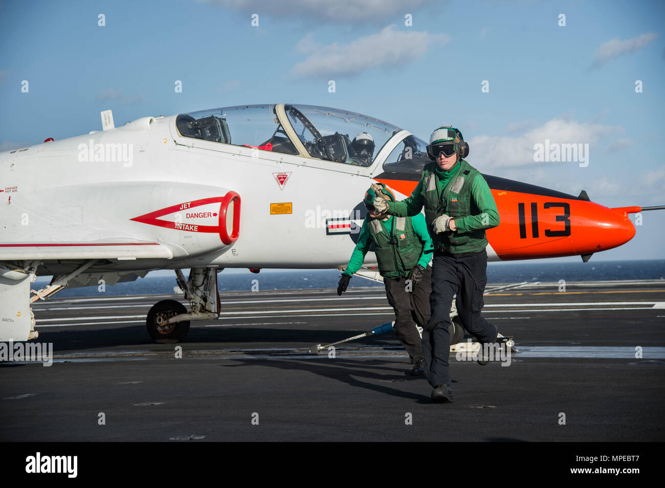 170210-N-OS569-097  ATLANTIC OCEAN (Feb. 10, 2017) Aviation Boatswain’s Mate Airman (Equipment), Bradley Stine, right, and Aviation Boatswain’s Mate 2nd Class (Equipment) Tyler Cantrall, complete their preflight inspection on the arresting gear of a T-45C Goshawk assigned to Carrier Training Wing (CTW) 1 prepares to launch from the flight deck of the aircraft carrier USS Dwight D. Eisenhower (CVN 69) (Ike). Ike is currently conducting aircraft carrier qualifications during the sustainment phase of the Optimized Fleet Response Plan (OFRP). (U.S. Navy photo by Mass Communication Specialist Seama Stock Photo