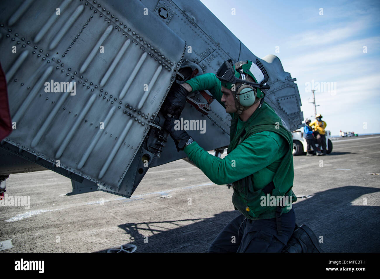 170209-N-OS569-050  ATLANTIC OCEAN (Feb. 9, 2017) Aviation Structural Mechanic 3rd Class Corbin Love conducts maintenance on an MH-60S Sea Hawk helicopter assigned to the Dragon Whales of Helicopter Sea Combat Squadron (HSC) 28 on the flight deck of the aircraft carrier USS Dwight D. Eisenhower (CVN 69) (Ike). Ike is currently conducting aircraft carrier qualifications during the sustainment phase of the Optimized Fleet Response Plan (OFRP). (U.S. Navy photo by Mass Communication Specialist Seaman Zach Sleeper) Stock Photo