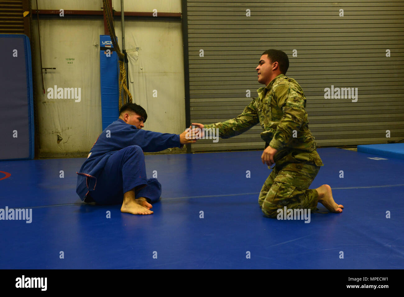 U.S. Army Staff Sgt. Joel Lung, U.S. Army Central battalion intelligence noncommissioned officer in charge, and Pfc. Melvyn Santos, U.S. ARCENT geospatial engineer, congratulate each other after a sparring match at Shaw Air Force Base, S.C., Feb. 7, 2017. Both Airmen and Soldiers can attend classes, including U.S. ARCENT combatives, at the Combative House. (U.S. Air Force photo by Airman 1st Class Destinee Sweeney) Stock Photo