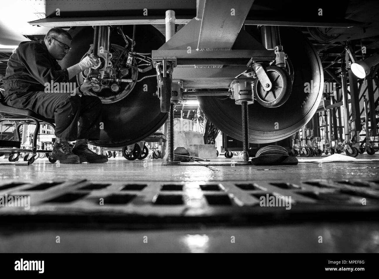 Tech. Sgt. Brandon Reed inspects the landing gear of a C-130H Hercules during an isochronal inspection on Feb. 14, 2017, at the 179th Airlift Wing, Mansfield, Ohio. The 179th Airlift Wing is always on a mission to be the first choice to respond to community, state and federal missions with a trusted team of highly qualified Airmen. (U.S. Air National Guard photo by Tech. Sgt. Joe HarwoodReleased) Stock Photo