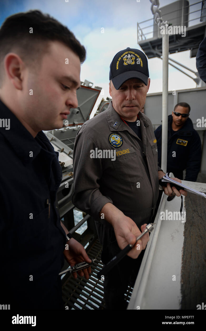 Naval inspectors conduct an inspection of ordnance jettison lockers ...