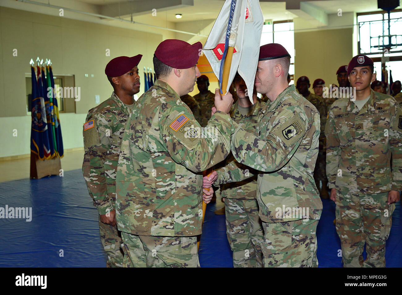 Capt. Shane R. Covert, right, passes the Echo Company guidon to Lt. Col. Benjamin A. Bennett, center, commander of 54th Brigade Engineer Battalion, 173rd Airborne Brigade, Feb. 15, 2017, during the change of command ceremony for Echo Company, 54th Brigade Engineer Battalion at Caserma Del Din in Vicenza, Italy. The 173rd Airborne Brigade based in Vicenza, Italy, is the Army Contingency Response Force in Europe, and is capable of projecting forces to conduct the full of range of military operations across the United State European, Central and Africa Commands areas of responsibility. (U.S. Army Stock Photo