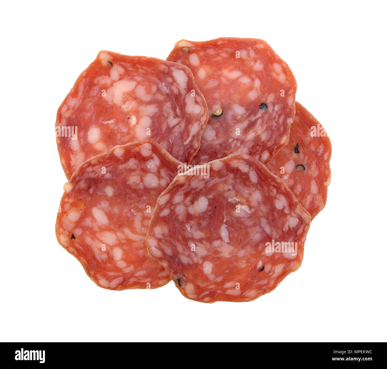Top view of several slices of uncured soppressata dry salami isolated