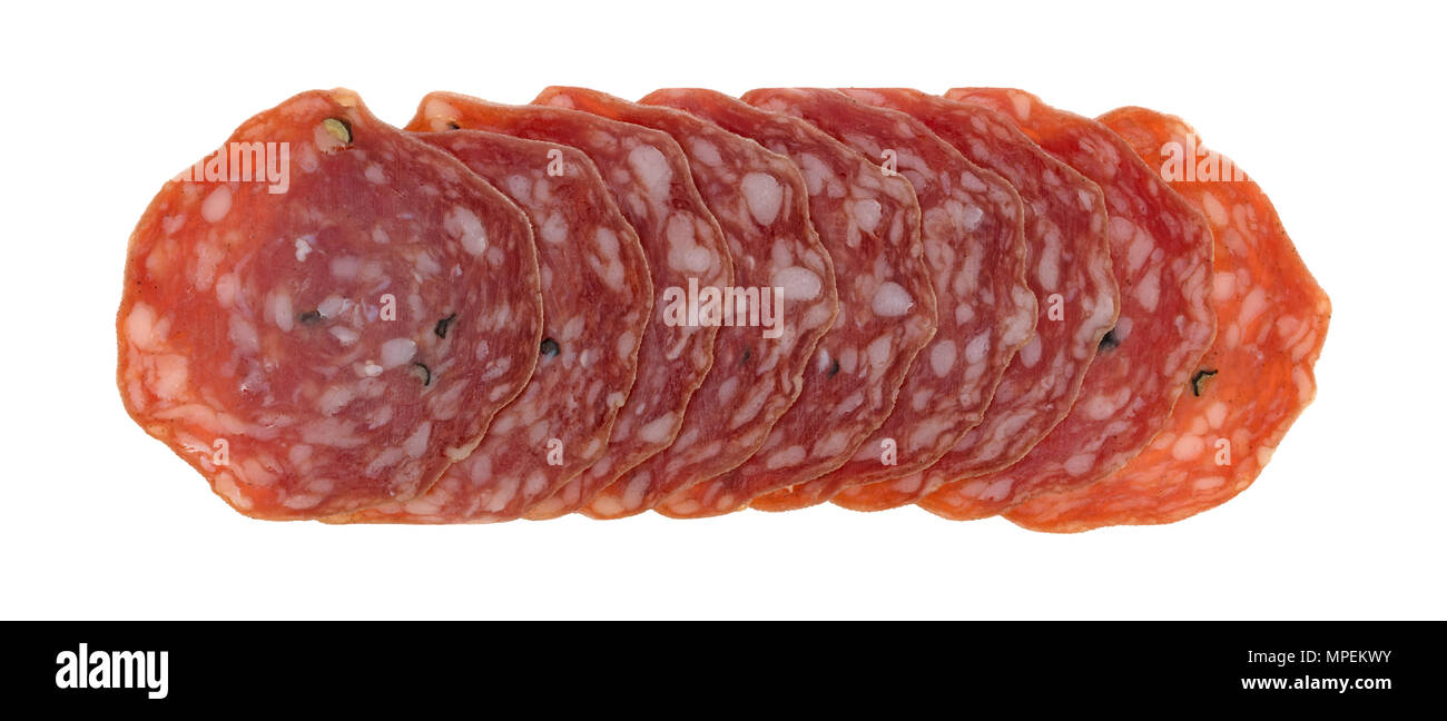 Top view of several slices of uncured soppressata dry salami in a row