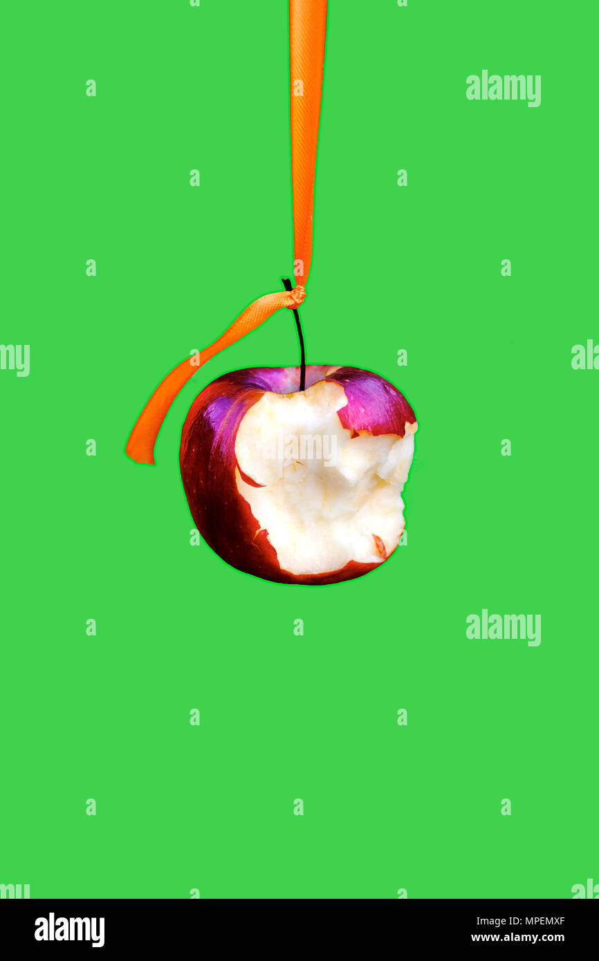 Half eaten dangling apple concept. Stock Photo