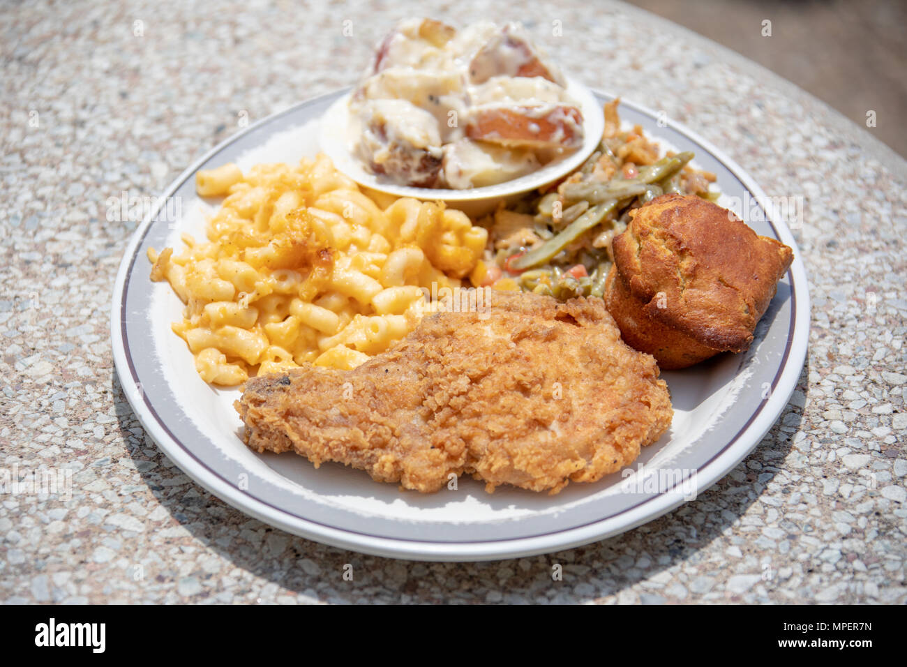 Breaded pork chop and sides at Derk's Filet and Vine Restaurant, Montgomery, Alabama Stock Photo