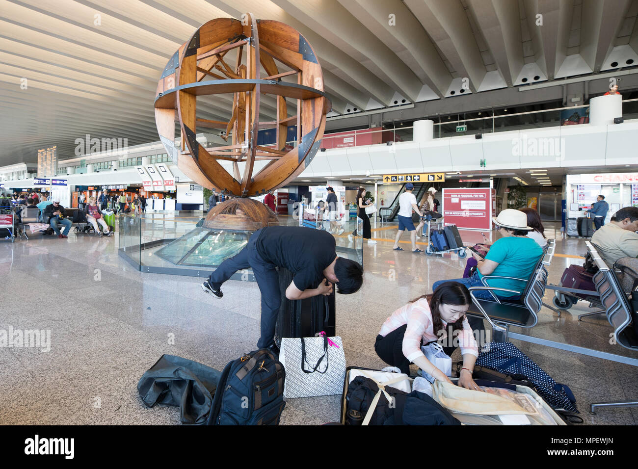Rome Fiumicino airport, interior scene passengers waiting fly, suitcase and luggage Stock Photo