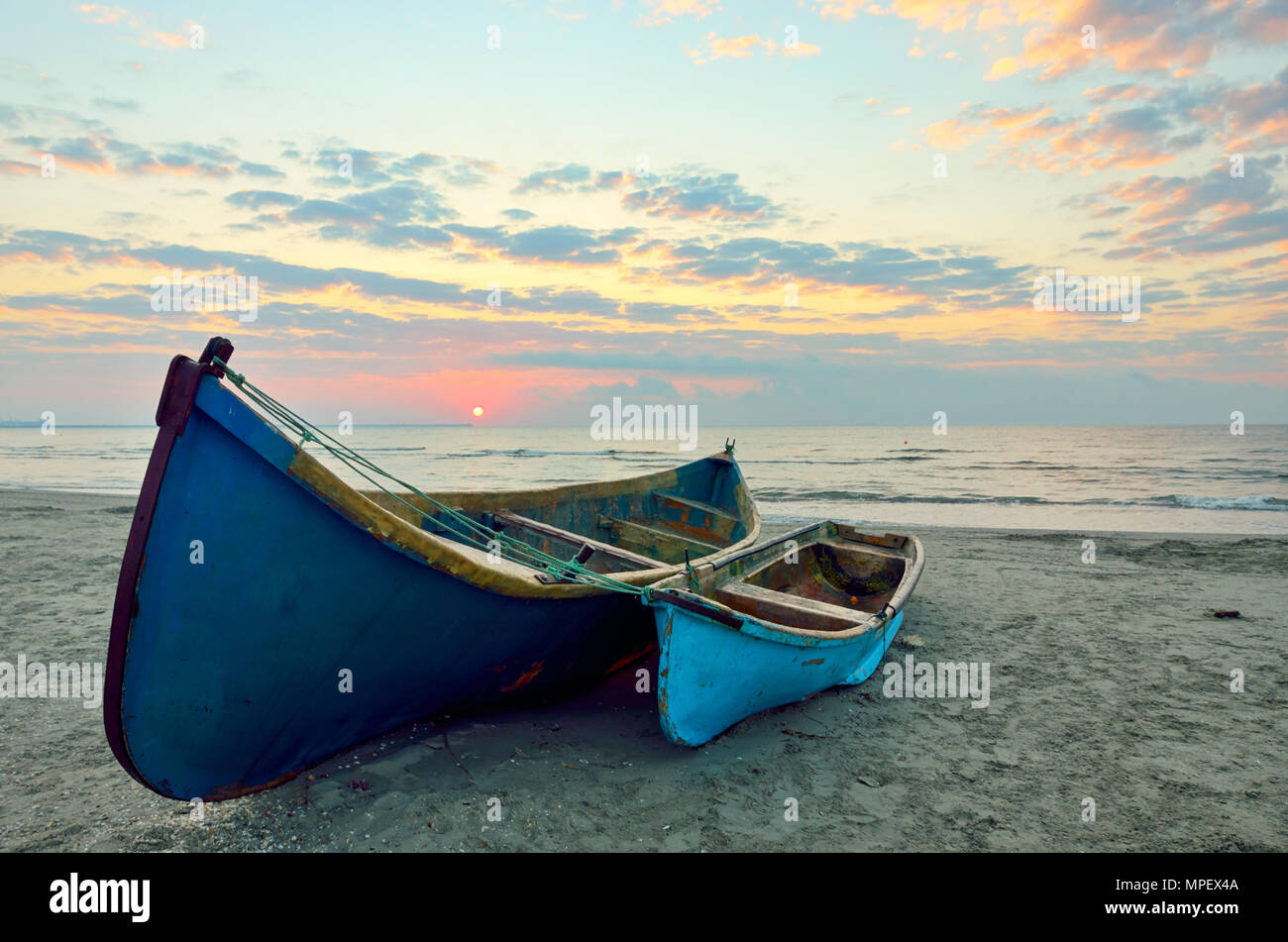 Fishing boats on the black sea beach at sunrise Stock Photo - Alamy