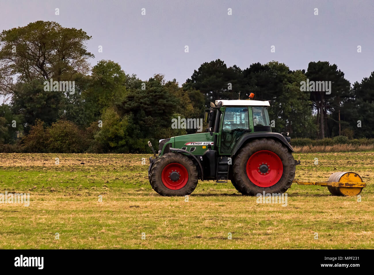 Tractor and roller working on a farm in Stokesley, North Yorkshire, UK Stock Photo