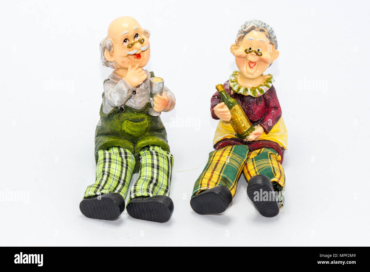 Pottery figurines of old couple drinking wine Stock Photo Alamy
