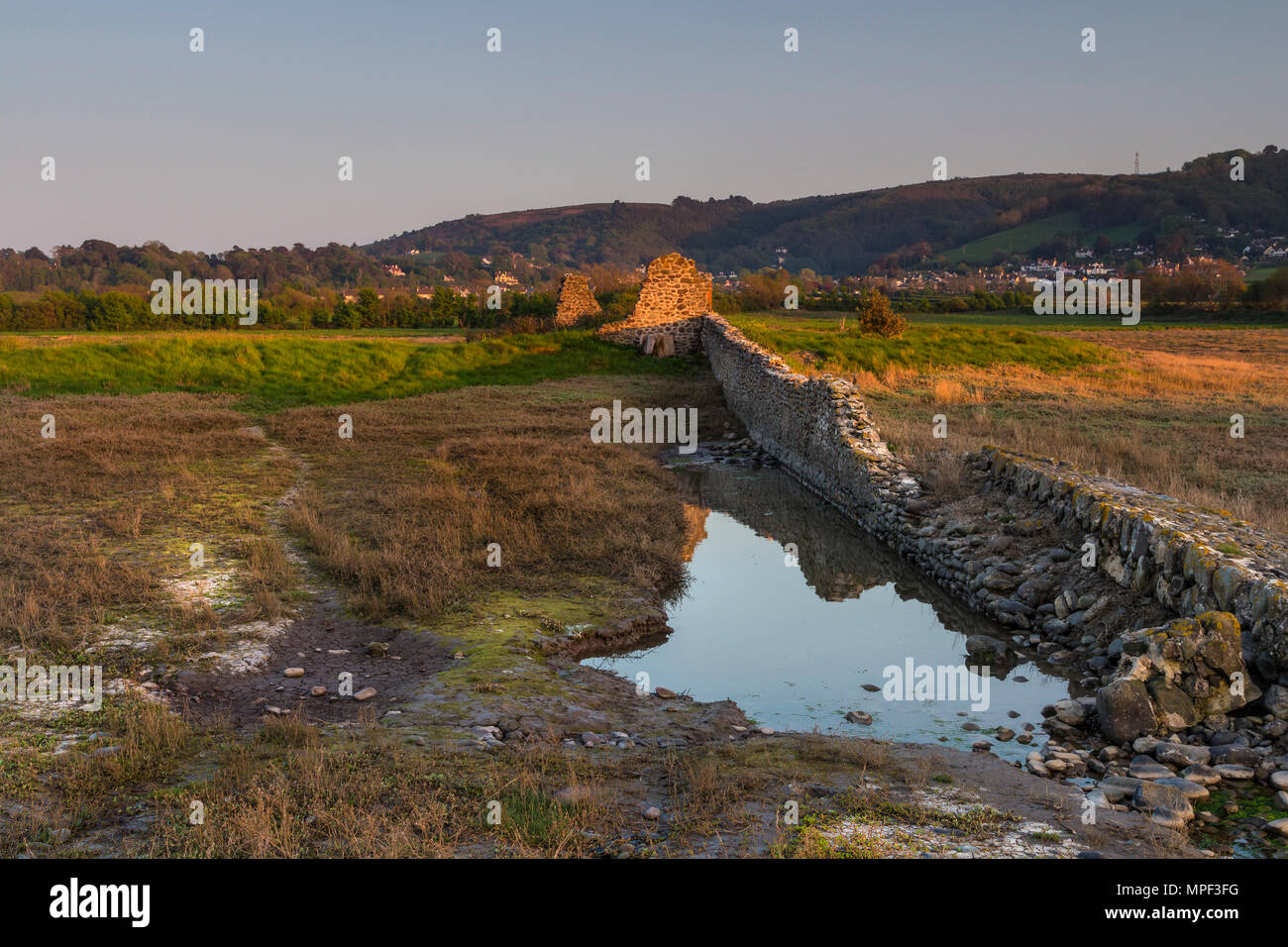 Last Light on the Remains of Buildings on Porlock Marsh, now Flooded Twice a Day at High Tide. Porlock, Somerset, UK Stock Photo