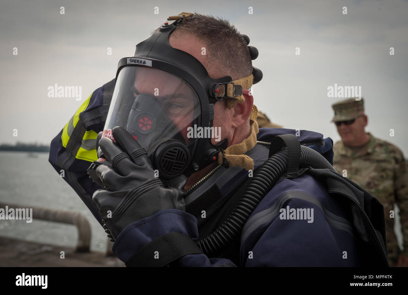 David Guerra, Miami-Dade Fire Rescue air rescue flight medic, dons an oxygen mask during a hazardous material decontamination exercise on the Port of Miami, Fla. Feb 18, 2017.The exercise was led by Miami-Dade Fire Rescue and U.S. Army North under the supervision of U.S. Northern Command and provided soldiers and first responders the unique experience of operating together in a major metropolitan city. (U.S. Air Force photo by Staff Sgt. Cory D. Payne) Stock Photo