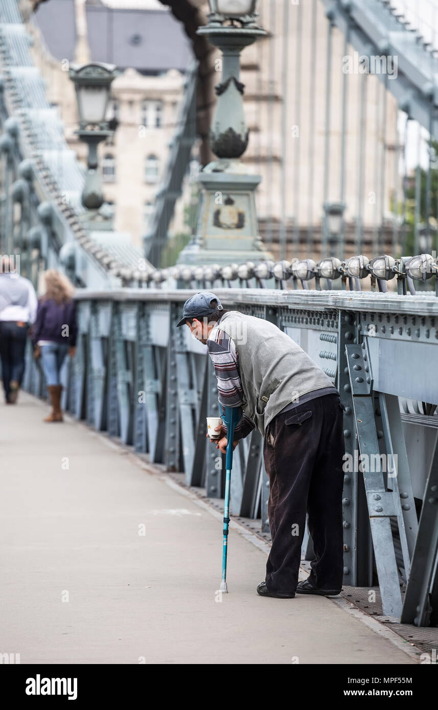 HUNGARY, BUDAPEST - MAY 03, 2014: A man disabled person begging on Chain Bridge in Budapest Stock Photo