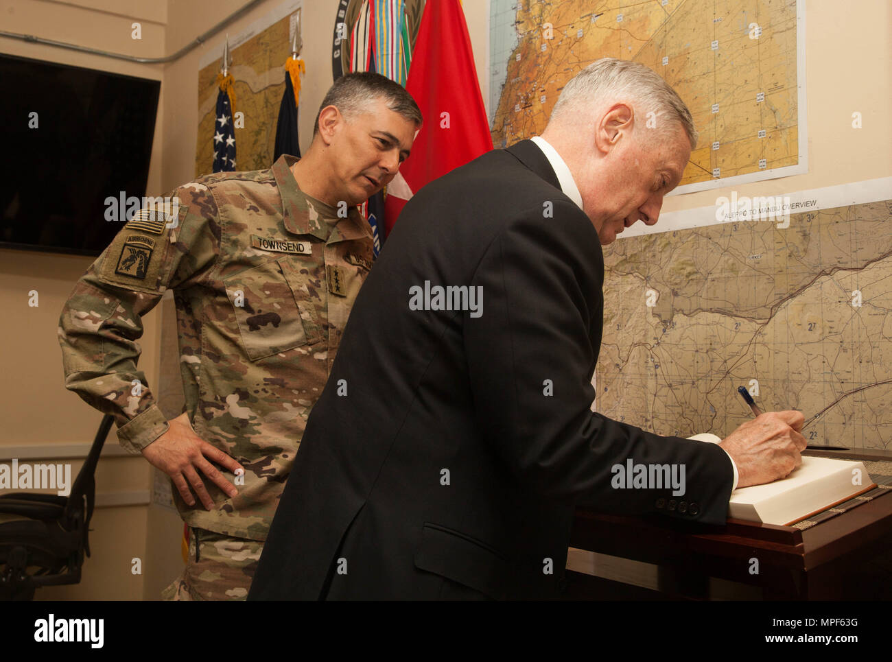 The Honorable James Mattis, United States Secretary of Defense, signs U.S. Army Maj. Gen. Townsend's guest book during his inaugural visit to Iraq in support of Operation Inherent Resolve in Baghdad, Iraq, Feb. 20, 2017. The breadth and diversity of partners supporting the Coalition demonstrate the global and unified nature of the endeavor to defeat ISIS in Iraq and Syria. (U.S. Army photo by Sgt. Joshua Wooten) Stock Photo