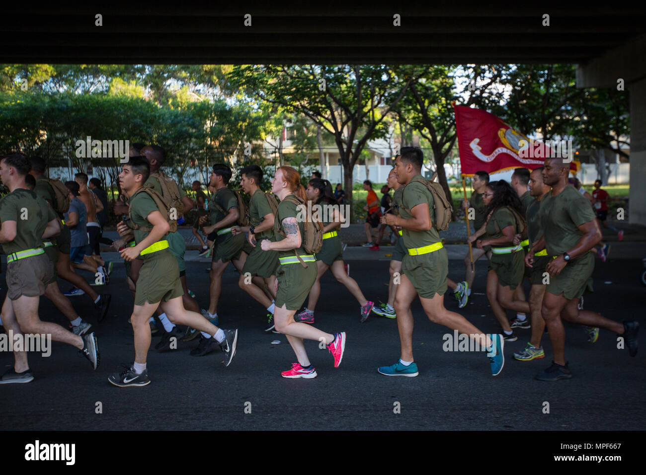 U.S. Marines with Combat Logistics Battalion 3, and U.S. Marine Corps Forces, Pacific, Headquarters and Service Battalion participate in the 33rd Annual Great Aloha Run in Honolulu, Hawaii, Feb. 20, 2017. Over 20,000 runners took part in the 8.15-mile run from the Aloha tower to the Aloha Stadium. (U.S. Marine Corps photo by Lance Cpl. Miguel A. Rosales) Stock Photo