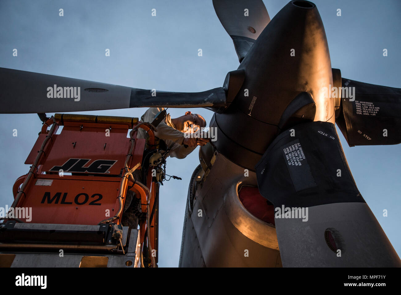 179th Airlift Wing Maintenance members work on the engine of a C-130H Hercules as the sun rises, Feb. 21, 2017, at the 179th Airlift Wing, Mansfield, Ohio.  The 179th Airlift Wing is always on mission to be the first choice to respond to community, state and federal missions with a trusted team of highly qualified Airmen. (U.S. Air National Guard photo by 1st Lt. Paul Stennett/Released) Stock Photo